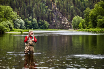 Fototapeta na wymiar Fly fishing in a forest river.