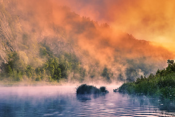 Obraz na płótnie Canvas Misty morning over a mountain river.