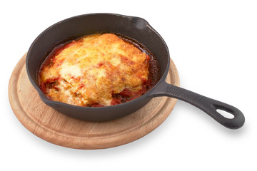 Traditional Italian dish, beef Lasagna in a cast iron pan on a wooden board. Isolated on White Background