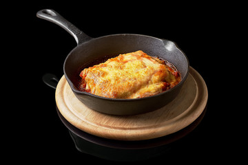 Traditional Italian beef lasagna with a lot of sauce in a pan.