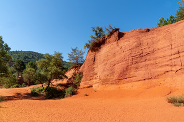 Blue sky beautiful red ochres luberon hills and green pines in Roussillon France