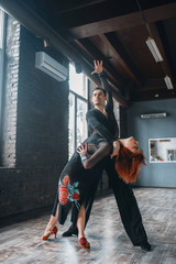 Man and woman on ballrom dance training in class