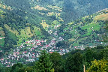 Naklejka na ściany i meble small town in the green mountain valley
