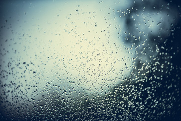 A small raindrops rests on the glass after rain.