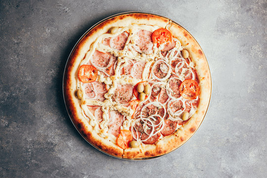 Flat lay of delicious pizza on gray background