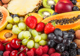 Naklejka na ściany i meble Fresh raw organic summer berries and exotic fruits. Macro. Close up. Pineapple, papaya, grapes, nectarine, orange, apricot, kiwi, lychees, cherry and physalis, raspberry.