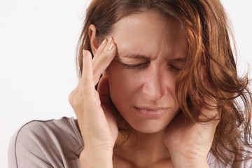 Studio shot of a young woman suffering from headache