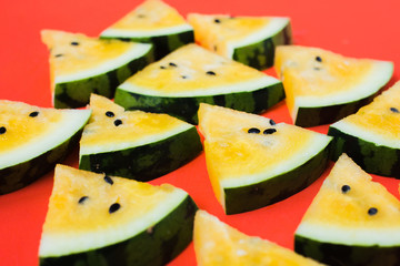 cut off triangular slices of ripe yellow watermelon on white background