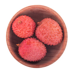 heap of lychees with rind isolated on white background in wooden plate