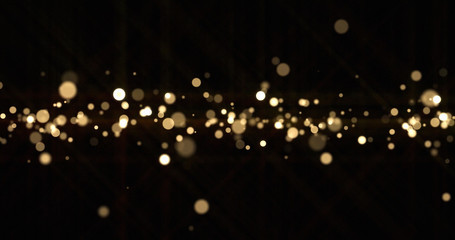Gold light bokeh sparks, golden glitter particles shine wave. Shiny bright snow bling effect, shimmering dust light and magic glow sparkles, Christmas luxury background © Ron Dale