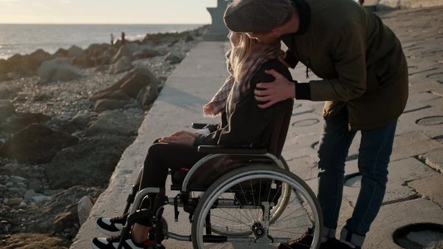 Handicapped woman with boyfriend near the sea
