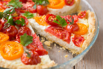 Tomato ricotta tart on wooden table