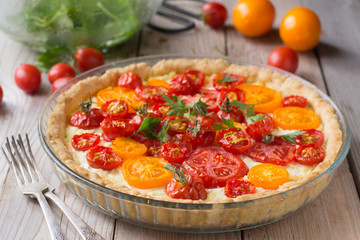 Tomato ricotta tart on wooden table