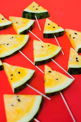 cut off triangular slices of ripe yellow watermelon on white background