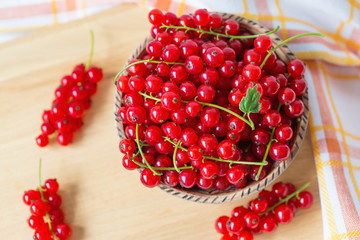 Fresh red currant berries in a bowl top view