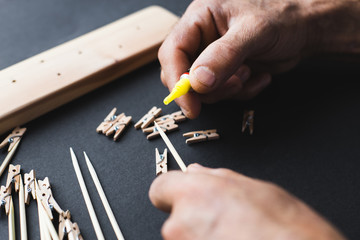 Fototapeta premium glue together wooden clothespins and sticks, make a holder for photos
