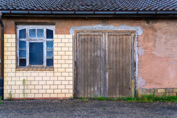 A house with old beautiful windows and a wooden door