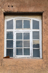 old rusted trowel in front of an old window