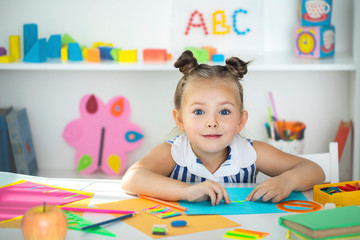 Early education. Little girl is educated at home.