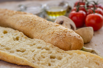 bread composition with herbs and vegetables on a baker's table
