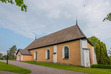 Fototapeta premium The church at Almunge village from 1100s in the rural area between Stockholm and Uppsala