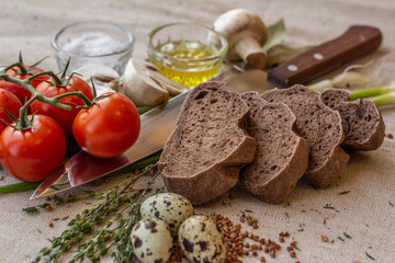bread composition with herbs and vegetables on a baker's table