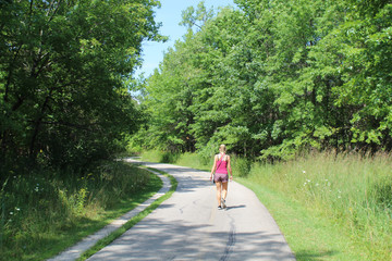 Young woman walking on the North Branch Trail in Chicago's Bunker Hill Woods Forest Preserve