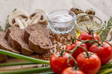 bread composition with herbs and vegetables on a baker's table