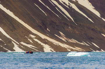 HORNSUND, SVALBARD, NORWAY – JULY 26, 2010:  Tourists in ocean rafts, Hornsund, Norway