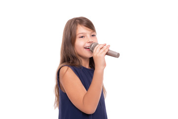 Little girl posing with a microphone for singing on a white background.