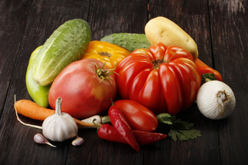 heap of different vegetables on wooden background