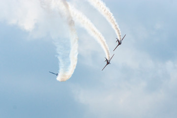 Airplanes on airshow. Aerobatic team performs flight at air show