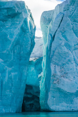 The end of a glacier in the Arctic Circle where it falls into the Arctic Ocean in Hornsund,...