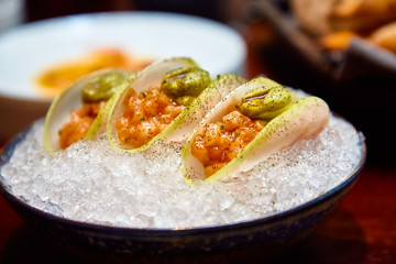 Ceviche or salmon tartare in daikon slices.