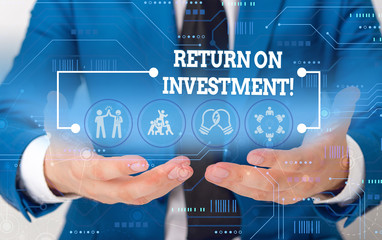 Conceptual hand writing showing Return On Investment. Concept meaning perforanalysisce measure used evaluate efficiency of investment Male wear formal suit presenting presentation smart device