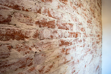 Weathered stained red brick wall background texture peeling plaster