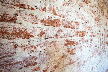 Weathered stained red brick wall background texture peeling plaster