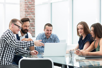 business team looking at the laptop screen and discussing their ideas