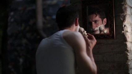 Serious boy shaving his beard