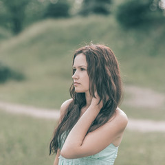 charming young woman on blurred background of nature.