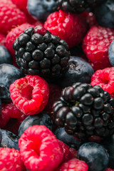 Fresh Summer Berries mix Background with Strawberry, Raspberry, Red currant, Blueberry and Blackberry.
