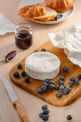 Camembert, blueberries, jam and croissant