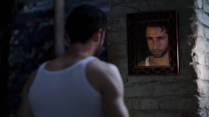 Man looks in the mirror.