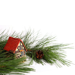 Christmas composition with a Christmas tree and a toy house. White background. There is a place for text.