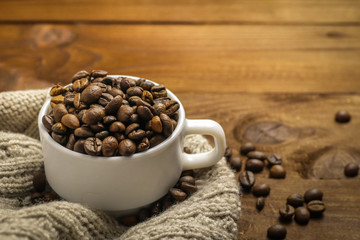 coffee cup and beans on wooden background