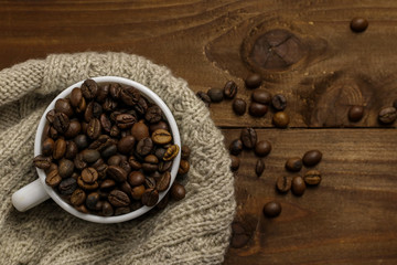 Cup with coffee grains on wooden table