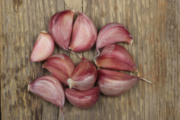 fresh heap of garlic cloves on wooden background