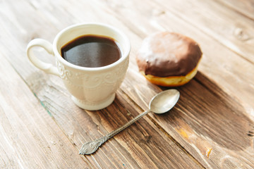 Tasty buns with raisins and a cup of coffee on a brown wooden table. fresh bakery. breakfast. bread. top view