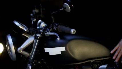  man repairing his motorcycle in the garage.