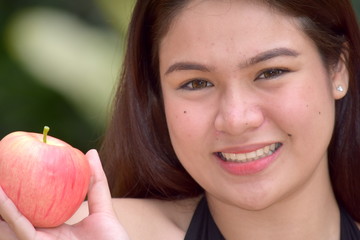 Smiling Youthful Diverse Female With An Apple